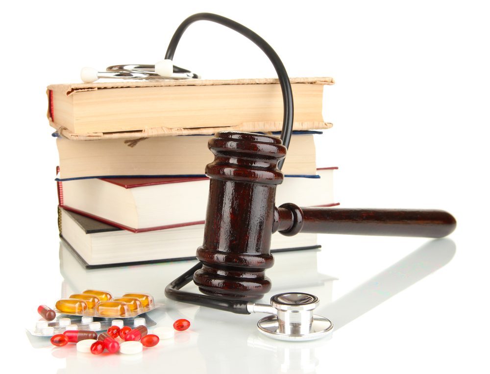 gavel with pile of books and pills