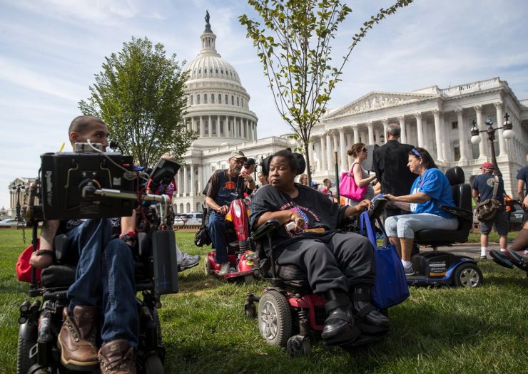 [Photo: People with disabilities rally outside of the U.S. Congress building.]