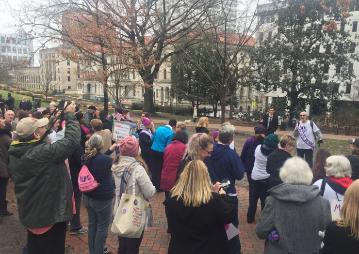 [Photo: A group of people rally in Virginia for Medicaid expansion.]