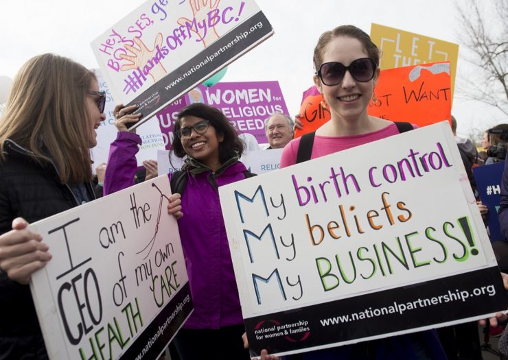 [Photo: Pro-Choice activists rally with signs. One poster reads 