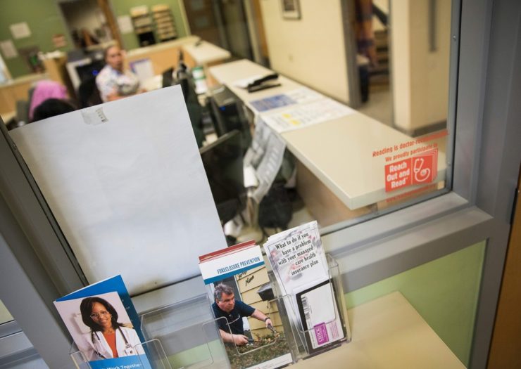 [Photo: Brochures for handling financial problems are seen in the waiting room]