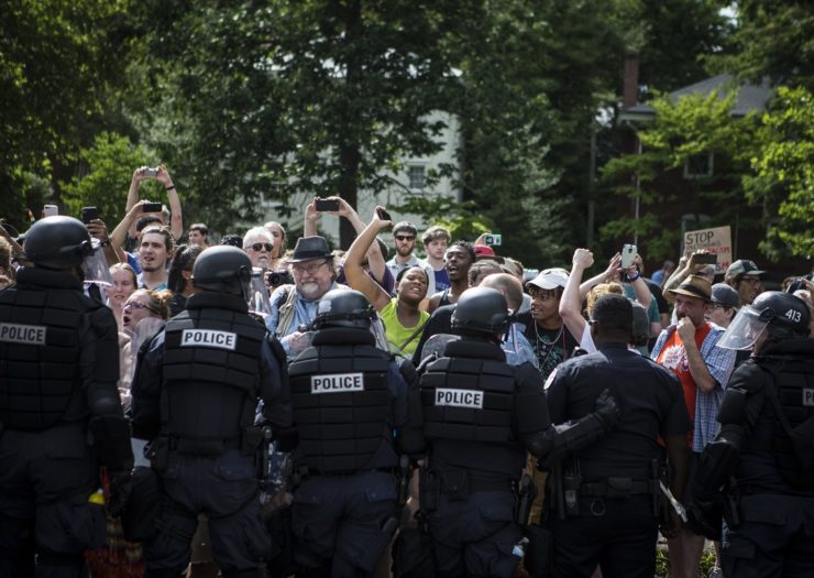 [Photo counter protesters are held back by riot police in Charlottesville, Virginia]