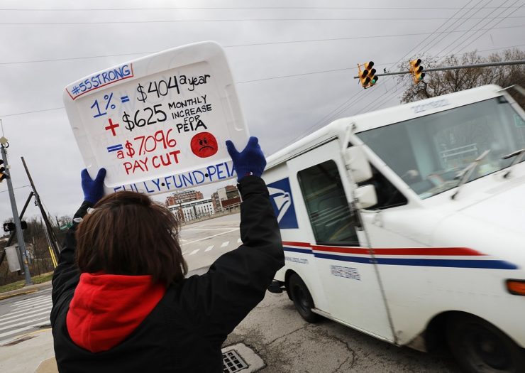 [Photo: West Virginia teachers, students and supporters hold signs on a Morgantown street as they continue their strike on March 2, 2018 in Morgantown, West Virginia. Despite a tentative deal reached Tuesday with the state's governor, teachers across West Virginia continued to strike.]