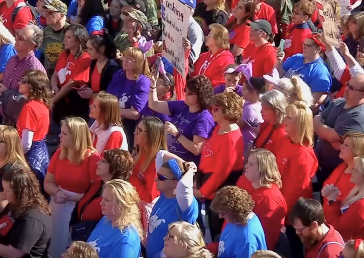 [Photo: A large crowd of teachers gather ouside of West Virginia's state capitol during the teachers strike.]