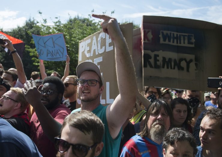 [Photo: Counter protesters shout at members of the Ku Klux Klan during a rally, calling for the protection of Southern Confederate monuments, in Charlottesville, Virginia]