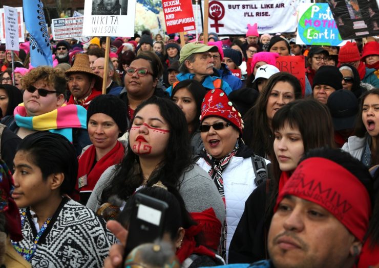 [Photo: A crowd of people listen speakers raising awareness of missing and murdered Indigenous women]