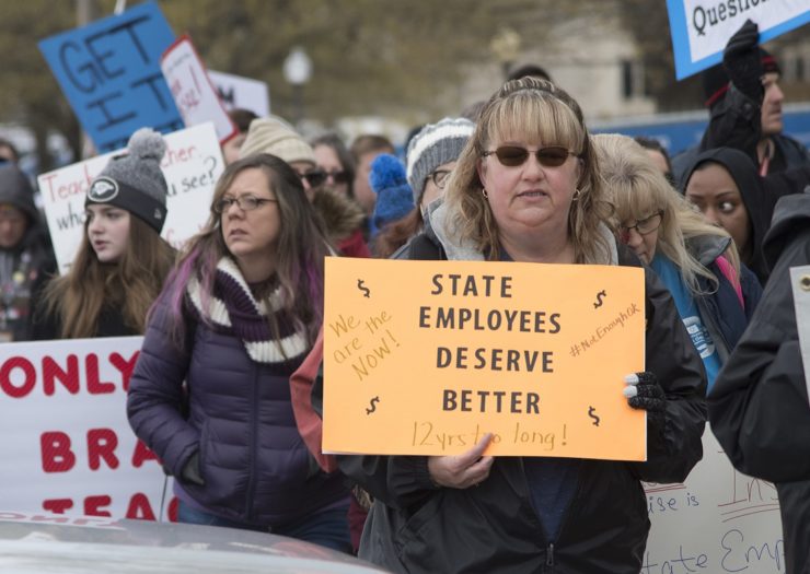 [Photo: An Oklahoman demonstrator holds a sign that reads 