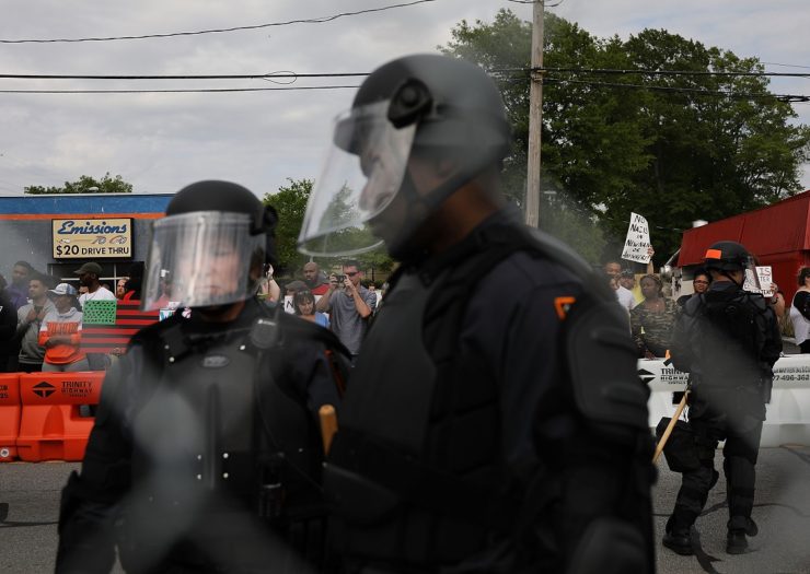 [Photo: Riot police stand between protesters and neo-Nazi's in Newnan, Georgia]