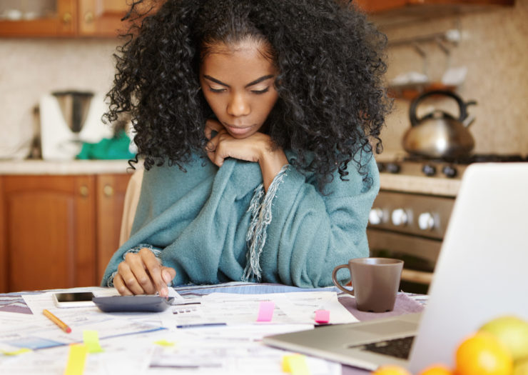 [Photo: Black woman calculating finances]