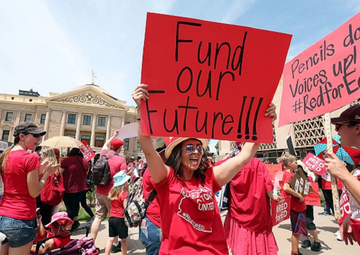 [Photo: Arizona teachers rally outside of the Arizona capitol. One sign reads 