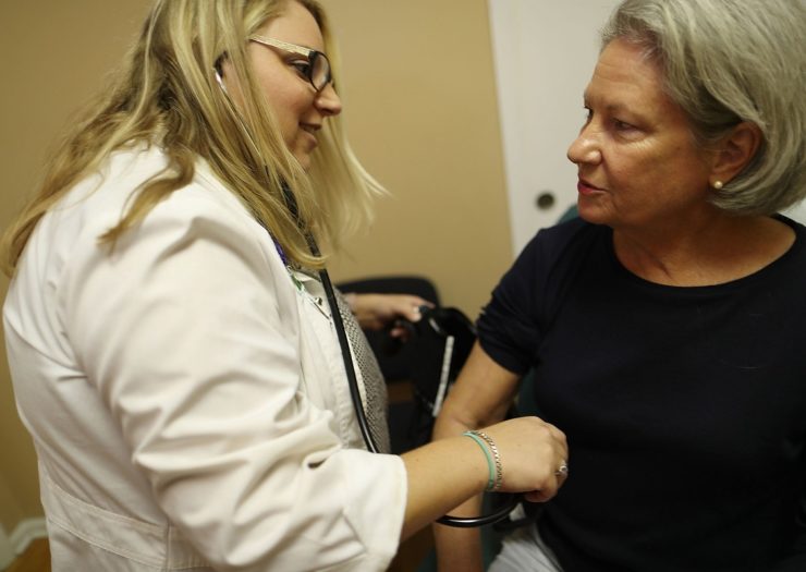 [Photo: A nurse practitioner does a checkup for a woman at a Planned Parenthood health center]