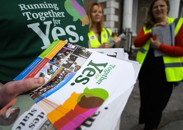 [Photo: Activists from the 'Together for Yes' campaign hold leaflets as they canvass for a 'yes' vote in the referendum to repeal the eighth amendment]