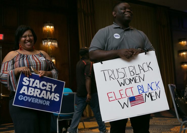 [Photo: Supporters of Georgia Democratic gubernatorial candidate Stacey Abrams holds signs that read 
