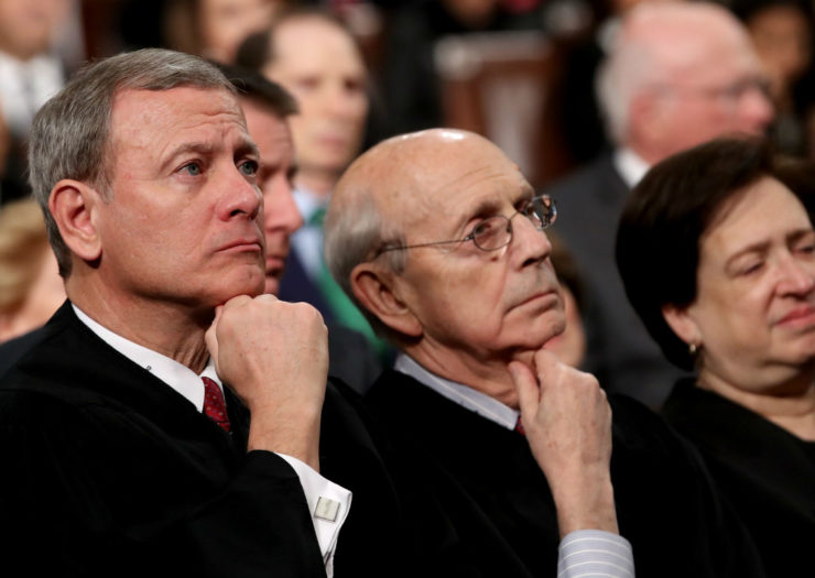 [Photo: Justices John Roberts, Stephen Breyer, and Elena Kagan look thoughtful in an audience.]