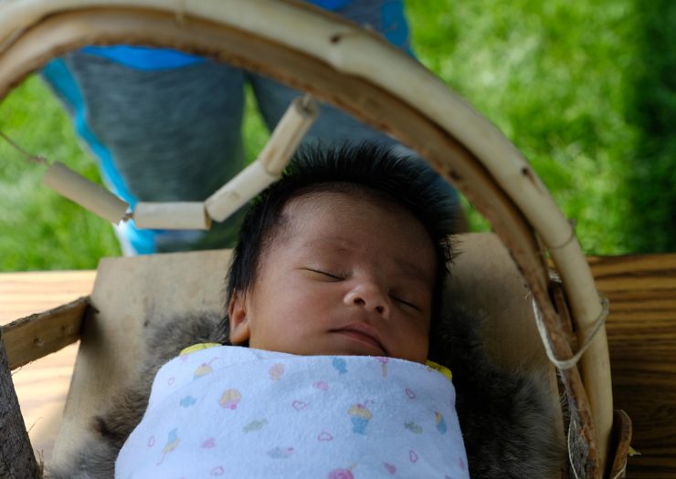 [Photo: A 3-week-old child named Jayceanna Charnoski sleeps in her new cradleboard]