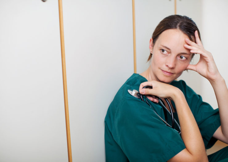 [Photo: A stressed nurse practitioner]