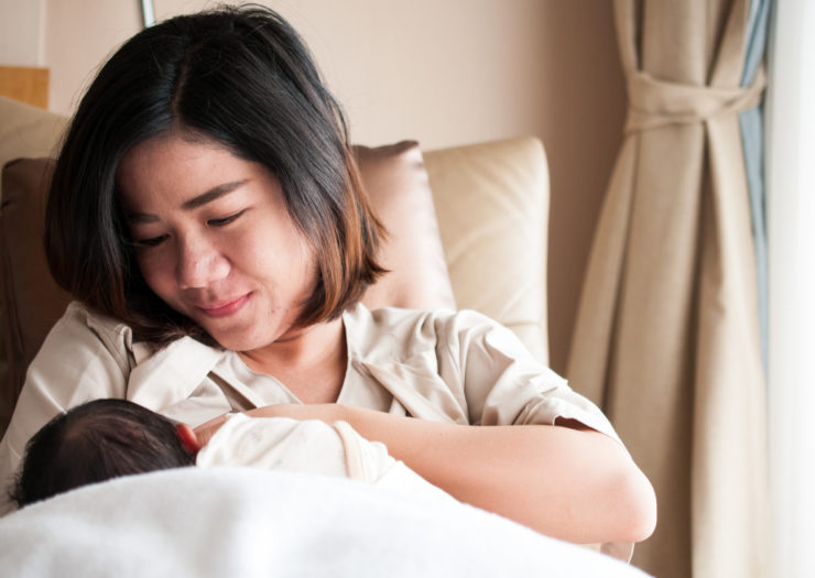 [Photo: A breastfeeding parent]