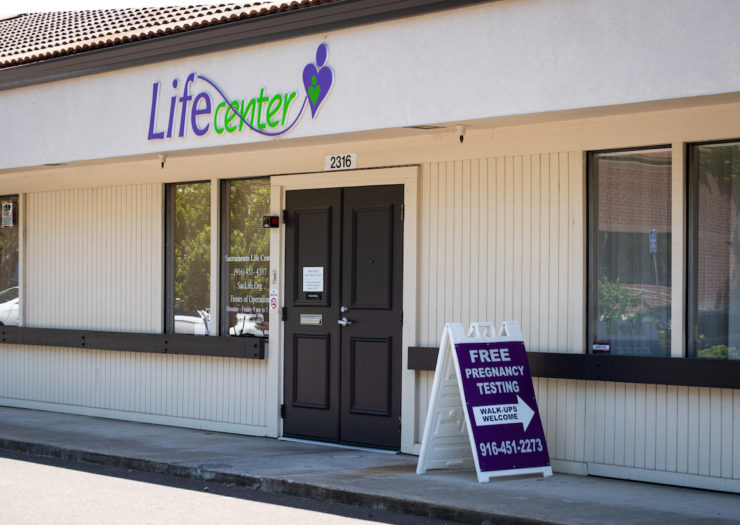 [Photo: Exterior of a crisis pregnancy center, including a sign that offers 