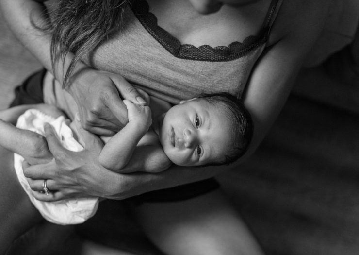 [Photo: Mother holding baby.]