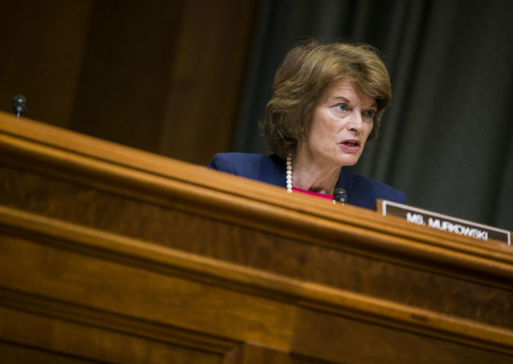 [Photo: Sen. Lisa Murkowski in front of a sign with her name on it.]