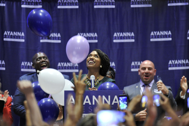 [Photo: Ayanna Pressley delivering her victory speech at the IBEW Local 103 in Dorchester, Massachusetts.]