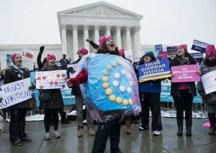 [Photo: Activists at the Supreme Court holding signs about birth control.]