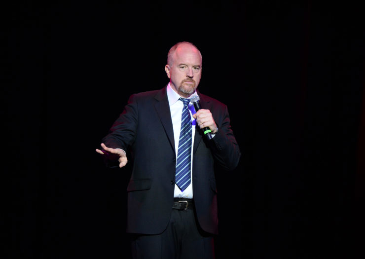 [photo: Louis C.K. performs a stand-up comedy routine.]