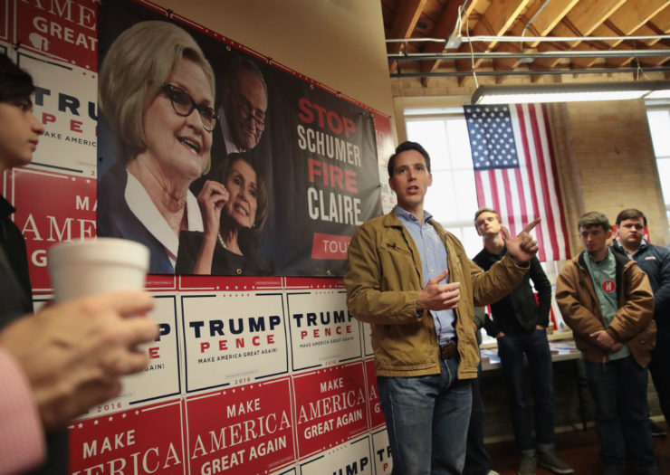 [Photo: Josh Hawley standing in front of Trump-Pence signs and other political posters.]