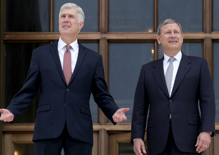 [Photo: Justices Neil Gorsuch and John Roberts stand on the steps of the Supreme Court building.]