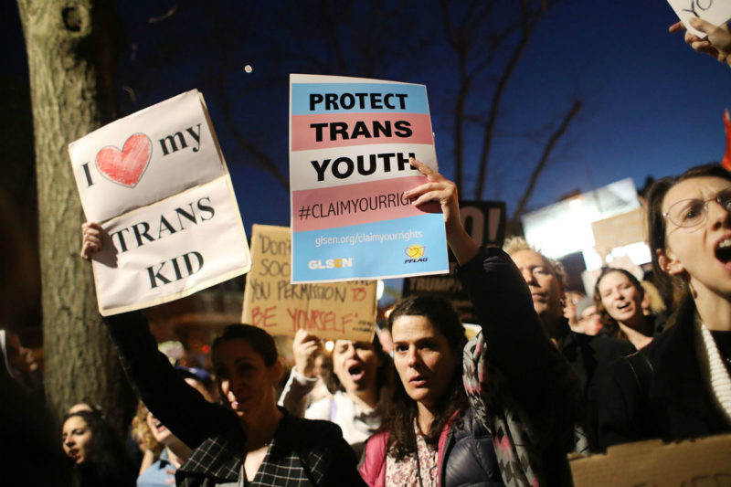 [Photo: Two protesters hold up