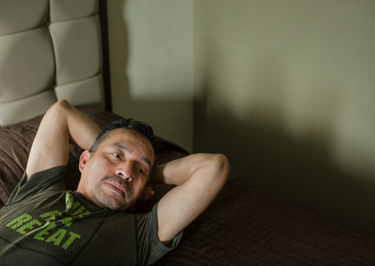 [Photo: Samuel Oliver-Bruno lying on a hotel bed]
