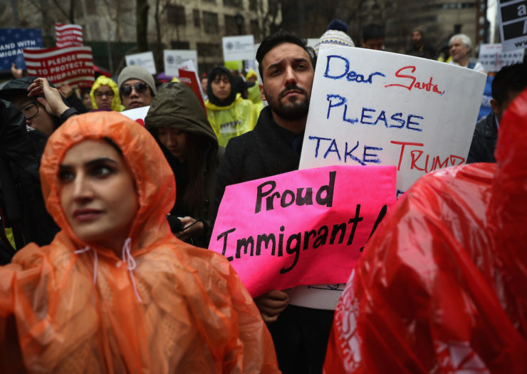 [Protesters in 2016 mark International Migrants Day by marching to Trump Tower from the UN.]