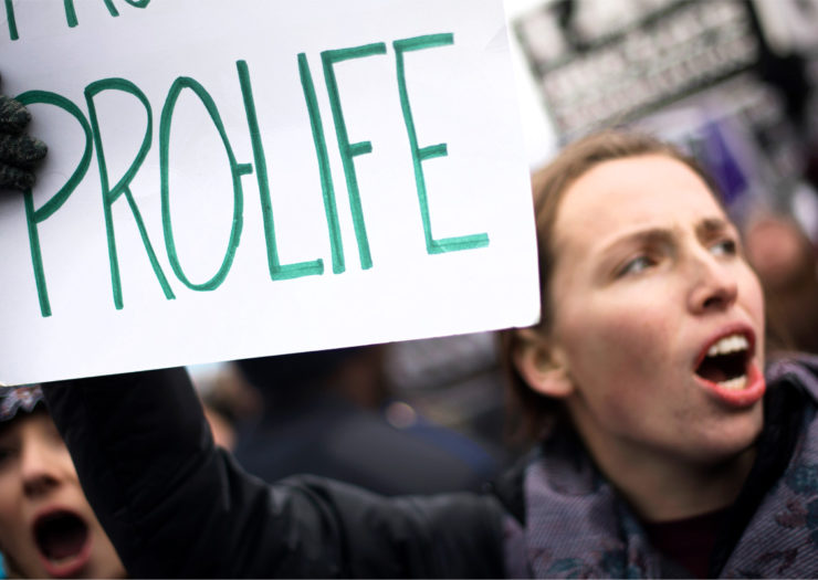 [PHOTO: An anti-choice activist demonstrates in front of the US Supreme Court.]
