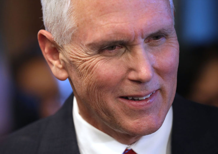 [Photo: Mike Pence smirking while at a conference.]