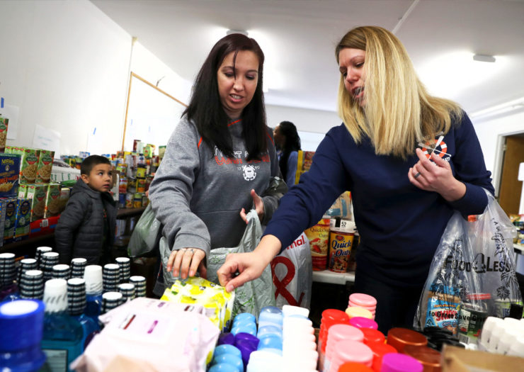 [Photo: U.S. Coast Guard families and other federal workers shop for free items during the government shutdown.]