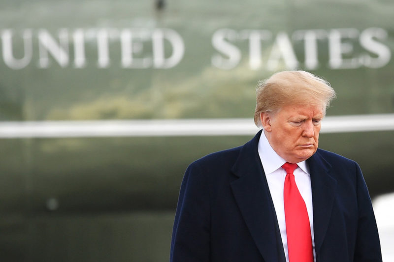 [Photo: President Trump dons a scowl as he walks away from Air Force One.]