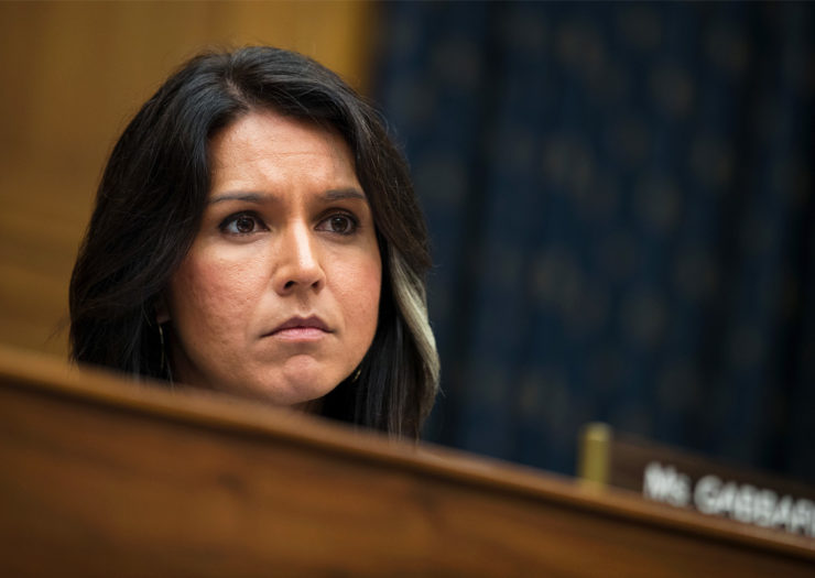 [Photo: Representative Tulsi Gabbard shows a face of concern as she listens to a testimony during a meeting on Capitol Hill.]