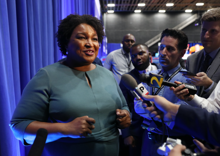 [PHOTO: Stacey Abrams talking to the press]