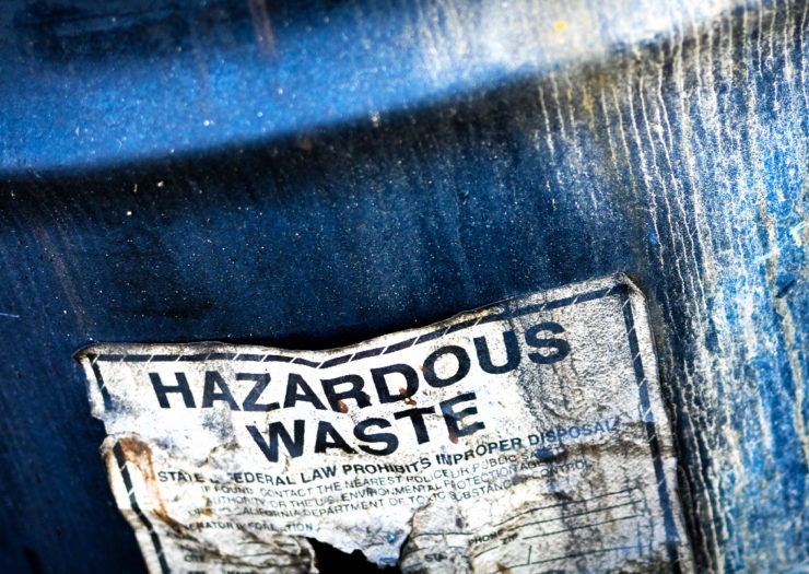 [Photo: A blue, toxic waste barrel.]