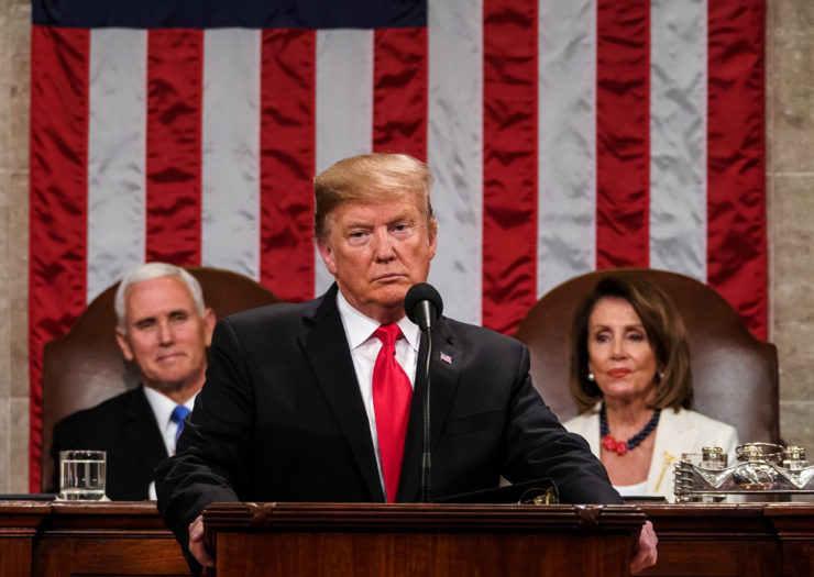 [Photo: President Donald Trump, with Speaker Nancy Pelosi and Vice President Mike Pence looking on, delivers the State of the Union address.]