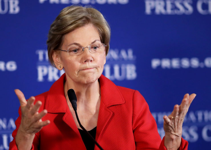 [Photo: Senator Warren gives an apologetic expression as she speaks at an event.]