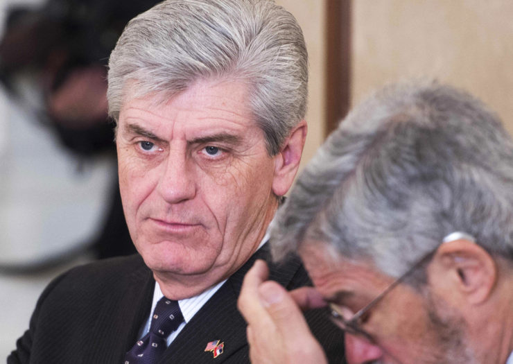 [Photo: Mississippi Governor Phil Bryant looks on during a meeting.]