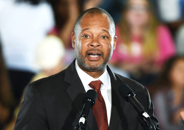 [Photo: Nevada attorney general Aaron Ford speaks enthusiastically during a rally.]