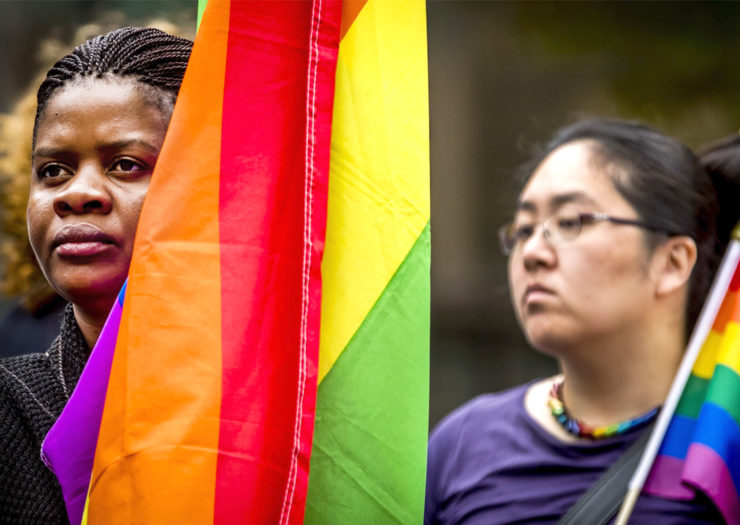 [Photo: Queer and trans migrant people of color rally in support of LGBTQ rights.]