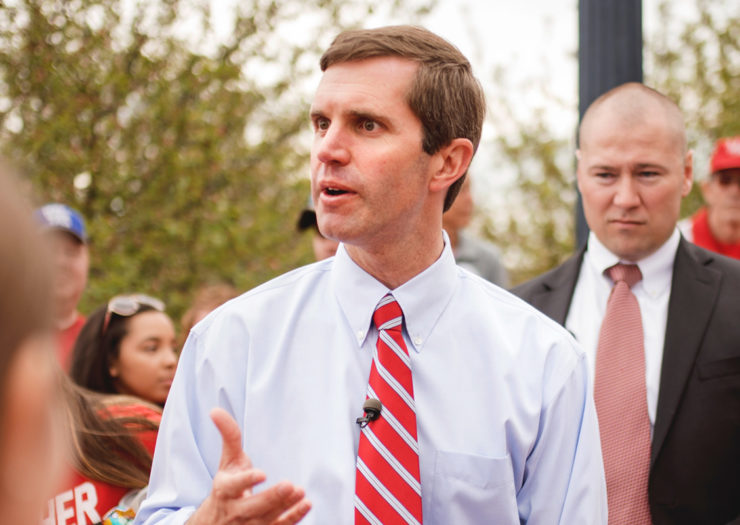 [Photo: Kentucky Attorney General Andy Beshear speaks to a crowd.]