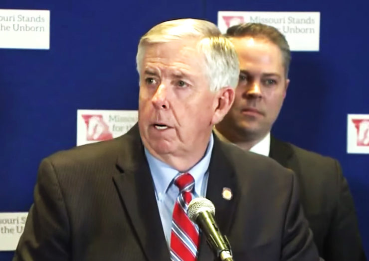 [Photo: Missouri Governor Mike Parson speaks at a press conference.]