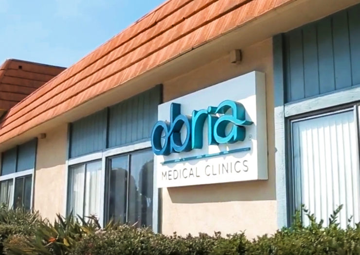 [Photo: An Obria Medical Clinics sign affixed to a clinic building.]