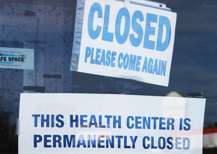 [Photo: A notice of permanent closure is taped on the door of an abandoned Planned Parenthood building.]