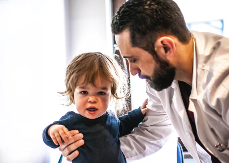 [Photo: A sweet baby gets examined by a pediatrician for dwarfism.]
