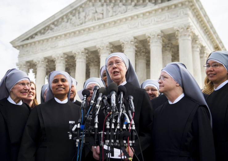 [Photo: Loraine Marie Maguire (C), mother provincial of the Little Sisters of the Poor, stands alongside fellow nuns as she speaks at a press conference in front of the Supreme Court.]